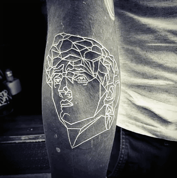 Outline Potrait Of Face Mens Sleeve Tattoo With White Ink Over Black Ink On Inner Forearm