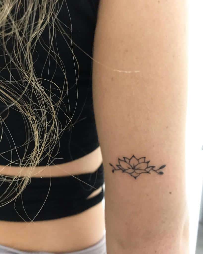 A lotus flower tattoo on a person's upper arm
