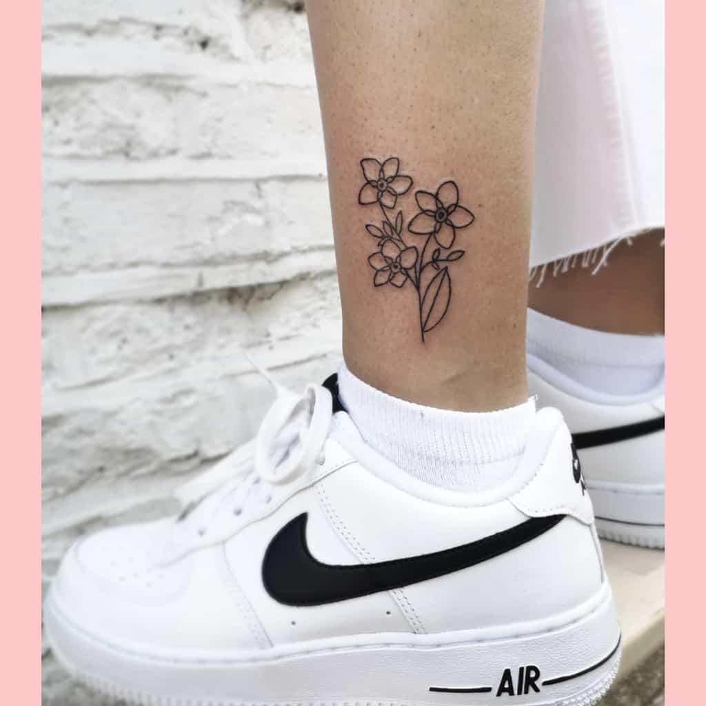 Minimalist floral tattoo on ankle