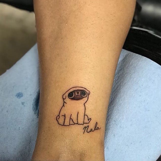 Tattoo of a small, cartoon-style pug with the name "Nala" written below