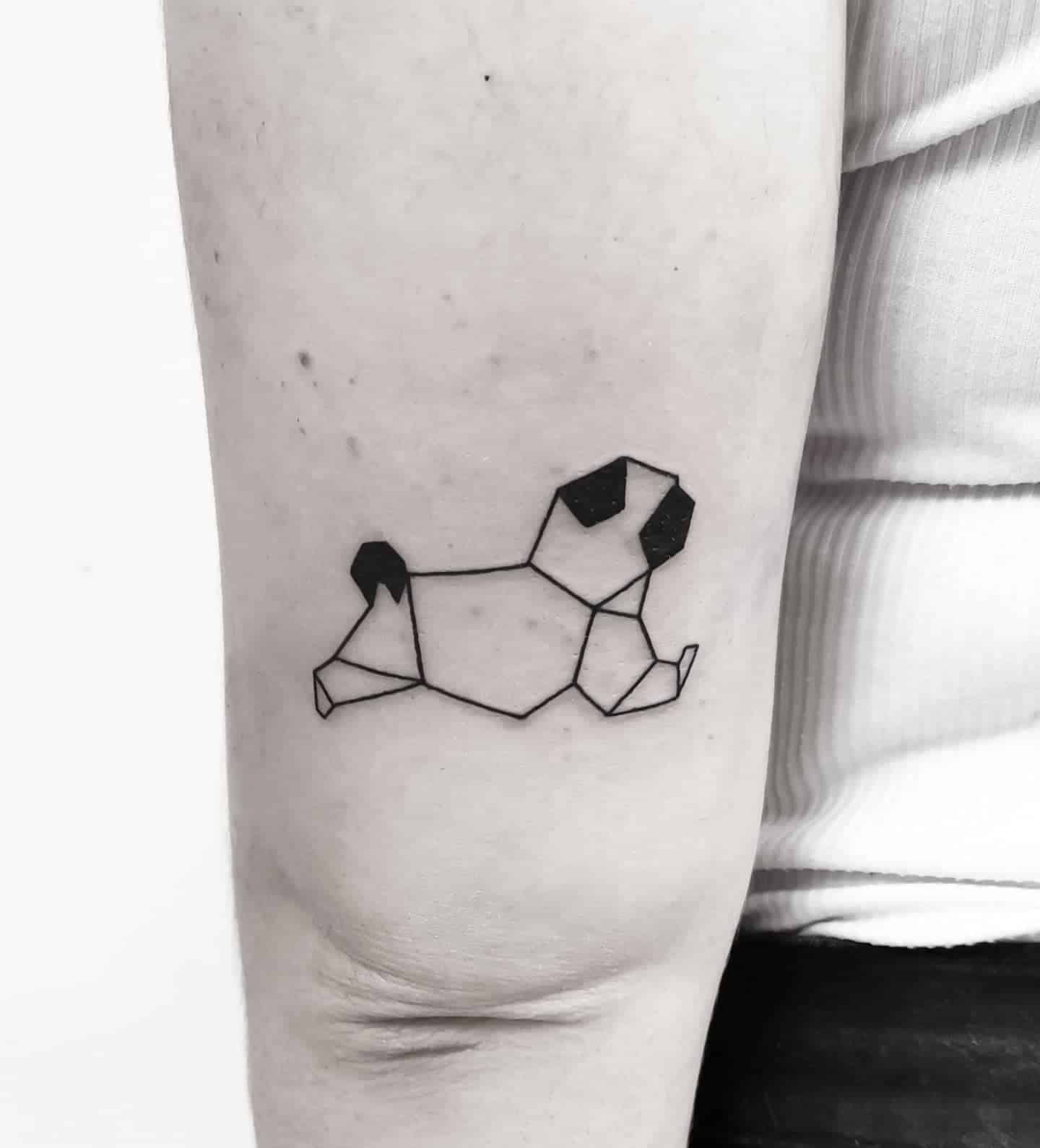 Geometric pug tattoo, featuring black shaded ears and tail