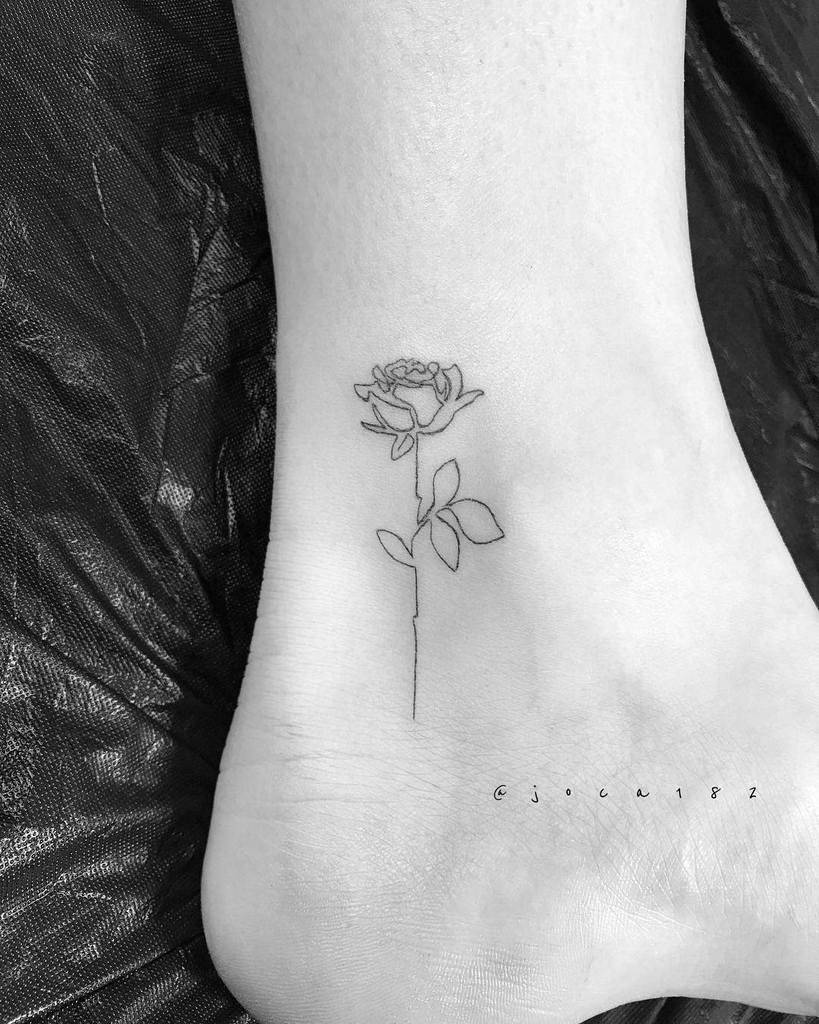 Line art rose tattoo on inner ankle