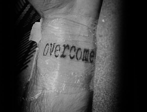 Overcome Single Word Tattoo Designs For Guys On Wrist