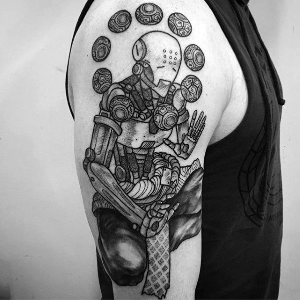 Black and grey tattoo of Zenyatta from Overwatch in a meditative pose with floating orbs, inked on the upper arm.