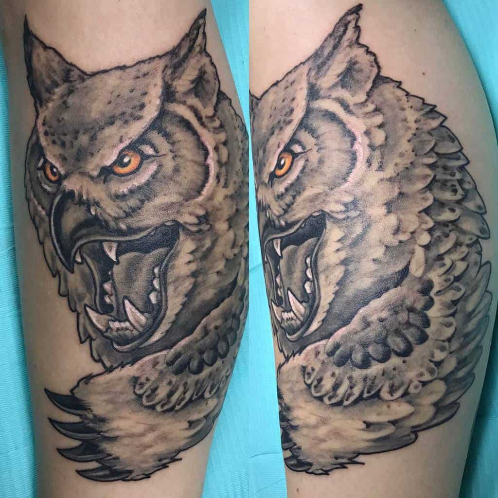 Realistic Dungeons & Dragons tattoo of a ferocious Owlbear with piercing orange eyes, sharp fangs, and detailed feathered fur