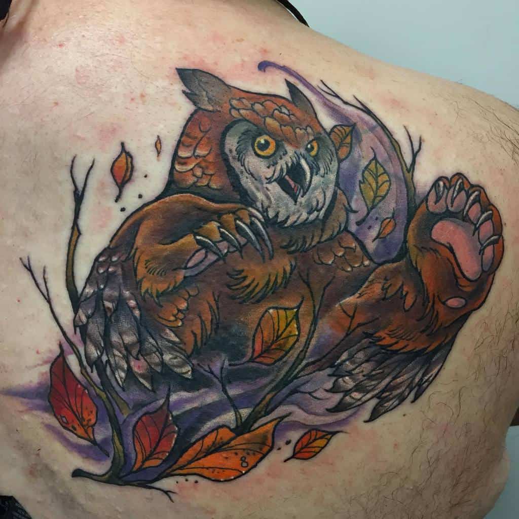 Vibrant Dungeons & Dragons tattoo of a fierce Owlbear leaping through autumn leaves, with striking eyes, sharp claws, and rich colors