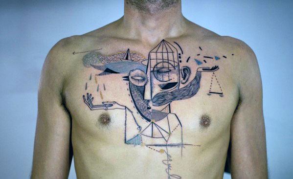 Surreal chest tattoo in Picasso’s style, featuring abstract faces, a caged head, geometric shapes, and symbolic elements like scales.