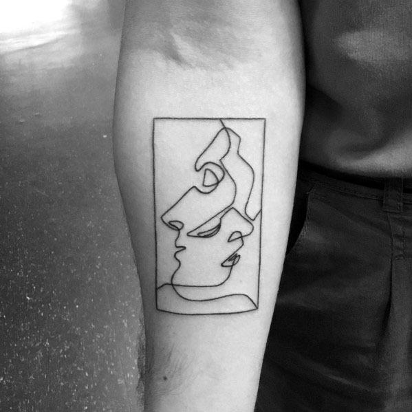 Single-line tattoo of abstract faces in a rectangular frame, inspired by Picasso’s continuous line drawing style.