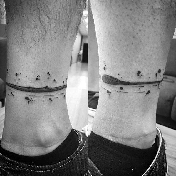 Minimalist paddle tattoo wrapped around the ankle with a water ripple effect, symbolizing movement, exploration, and a connection to nature.