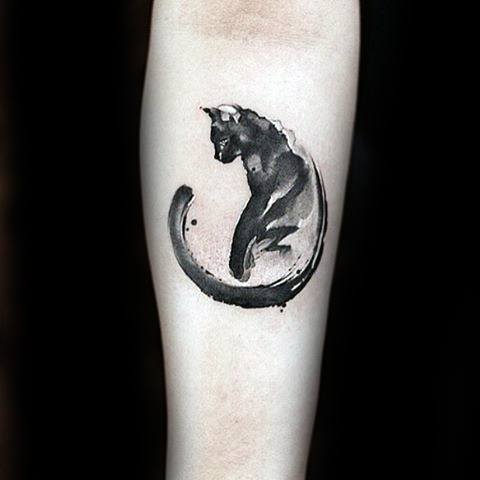 Elegant watercolor-style cat tattoo with a brushstroke effect, creating a fluid and artistic design on the forearm.