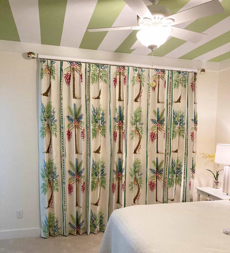 green and white stripe ceiling with floral curtains