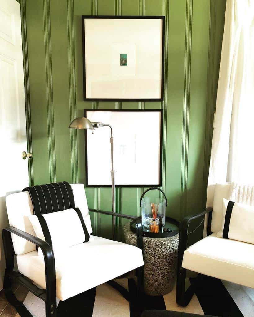 green painted wall paneling white sofas