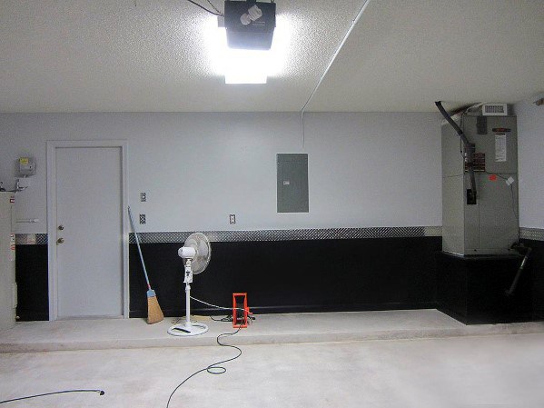 unfinished garage with white and black walls with diamond plate divider