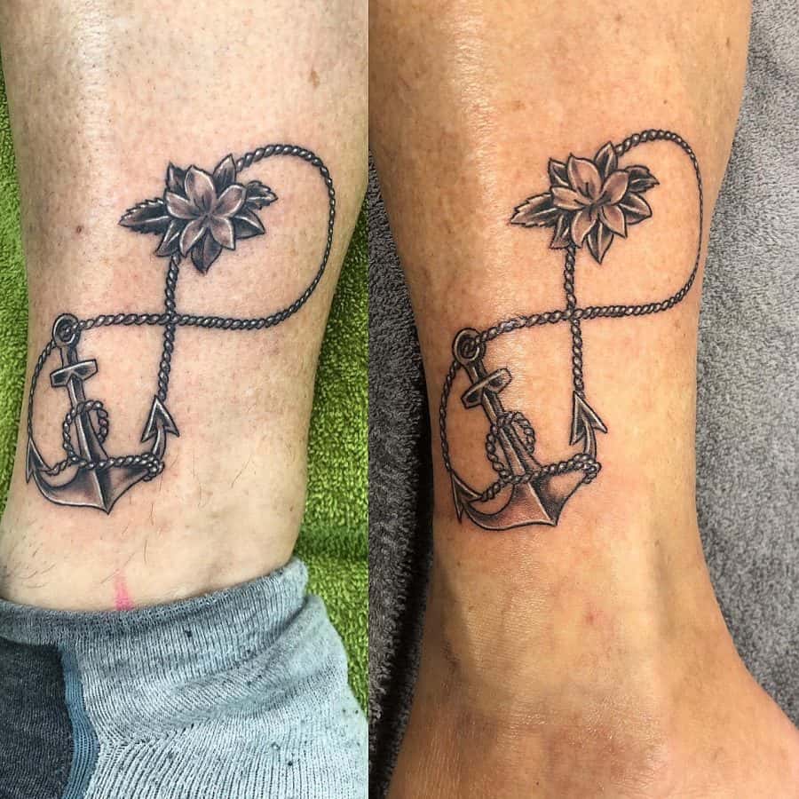 A meaningful tattoo featuring an anchor connected by a rope to a lotus flower, symbolizing strength, stability, and spiritual growth.
