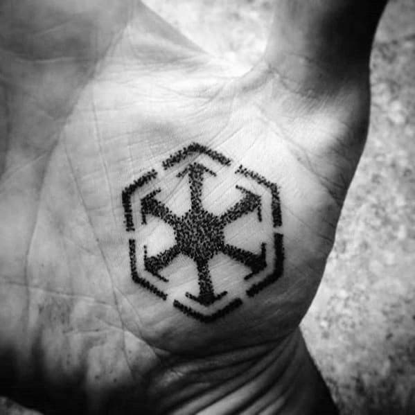 Detailed Sith Empire symbol tattooed in black dotwork style on the center of the palm, blending precision with bold placement.