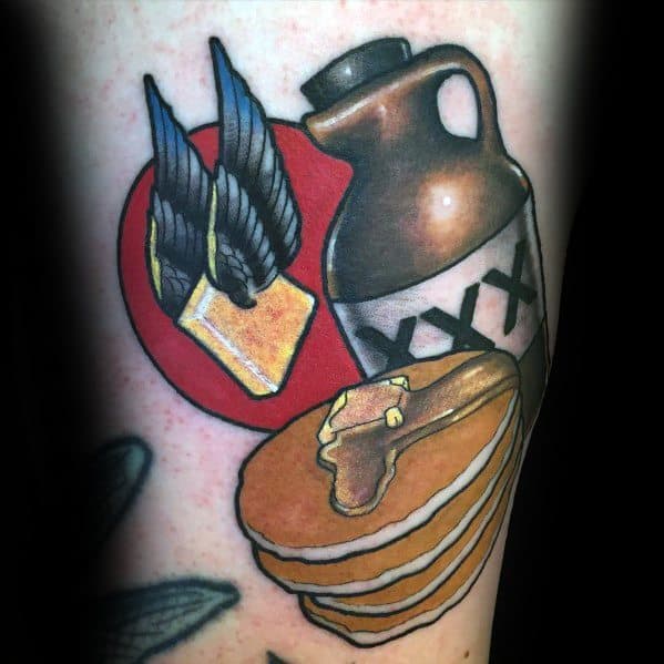Bold pancake tattoo featuring a syrup jug, a stack of pancakes with butter, and a winged pat of butter, designed in a vintage Americana style.