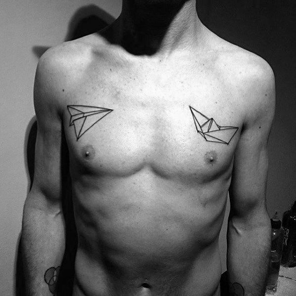 Minimalist chest tattoos of a paper airplane and paper boat, symbolizing adventure, freedom, and the balance between air and water.