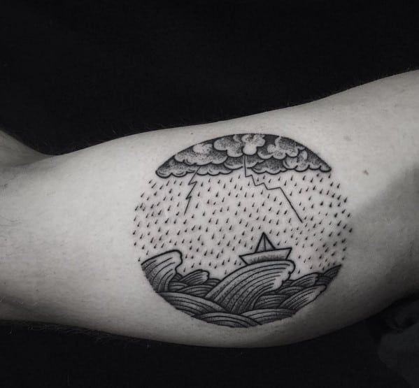 Black ink circular tattoo of a paper boat in stormy seas with lightning and rain, symbolizing resilience and navigating life's challenges.