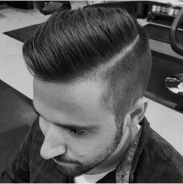 Neat side part with a hard part and a clean fade