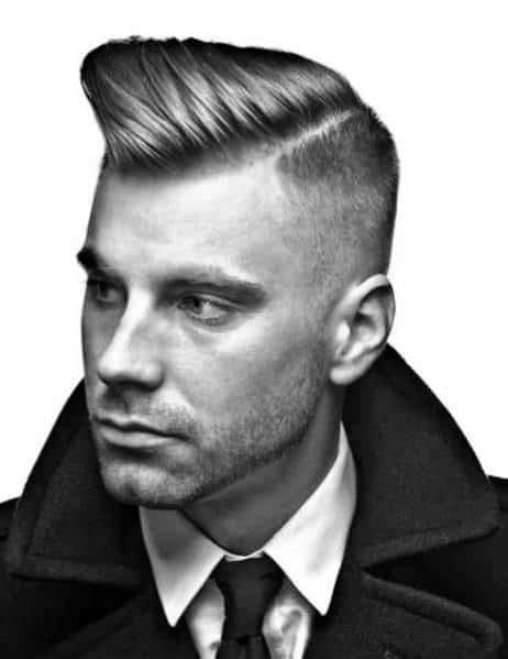 High pompadour with a sharp side part and a clean fade