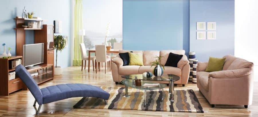 pastel blue wall living room with glass coffee table 