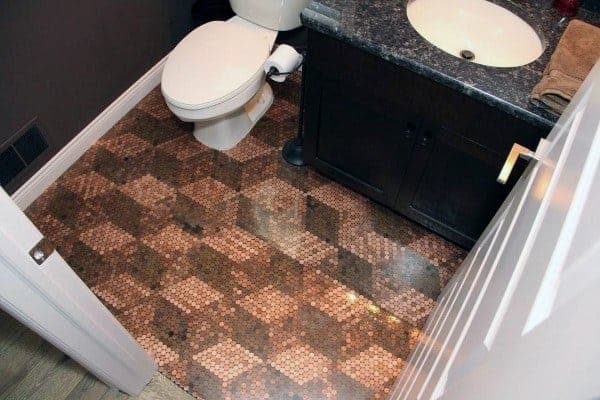 Bathroom with penny tile floor in a checkered pattern and dark vanity with granite countertop.
