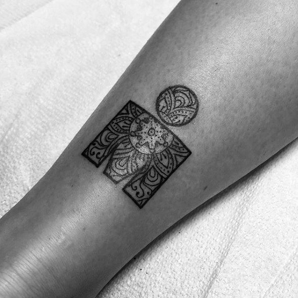 Ironman logo tattoo on the lower leg filled with detailed mandala and floral patterns in fine blackwork for a delicate, ornamental look.