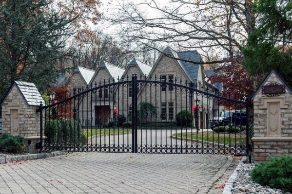 Paver driveway with a neat, uniform design and gated entrance.