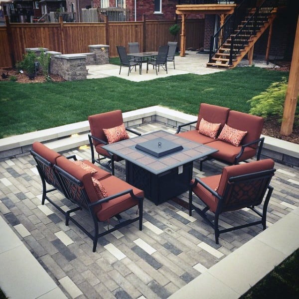 Elegant paver patio with cushioned seating around a fire pit, perfect for cozy backyard gatherings.