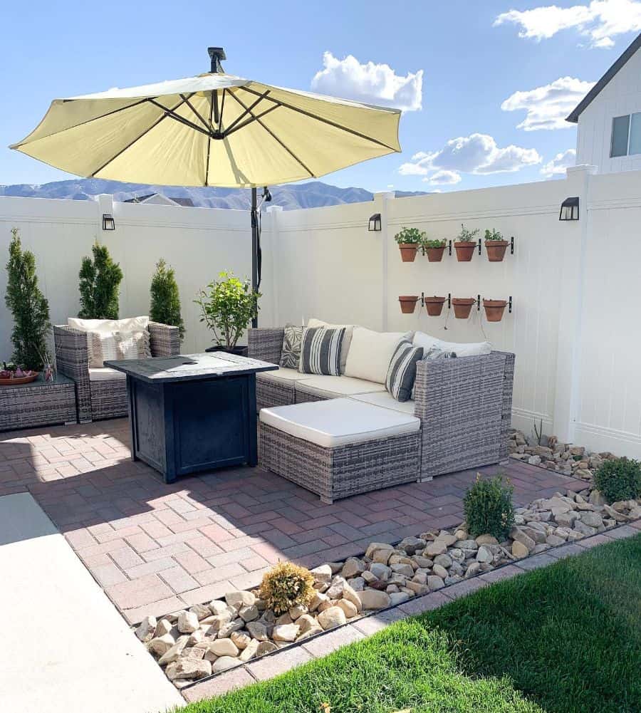 bright and airy brick paver patio with wicker furniture