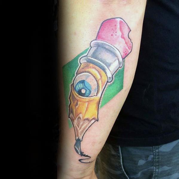 A tattoo of an eye skillfully nestled within a classic pencil, complete with a pink eraser, elegantly adorns a person's forearm