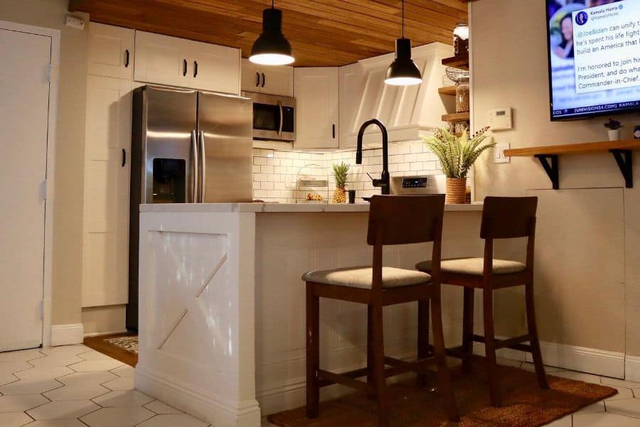 peninsula kitchen wood bar two seats tile floor