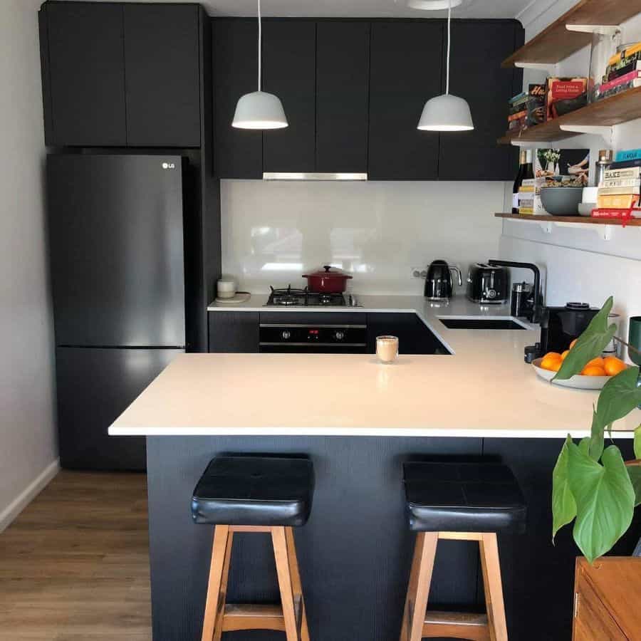 small peninsula kitchen bar black cabinets pendant lights wall shelves