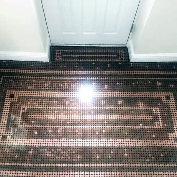 Intricate rectangular pattern on a penny floor, sealed with a shiny epoxy finish for added depth and durability.