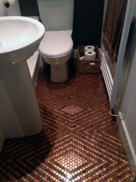Bathroom with penny tile flooring in a diamond pattern, white fixtures, and woven basket storage.