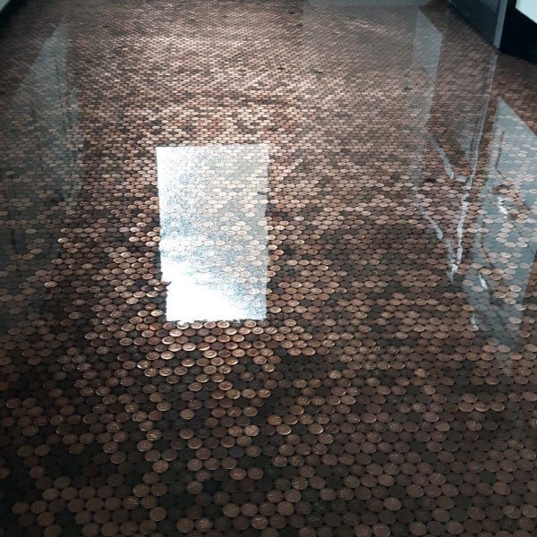 Highly reflective epoxy-coated penny floor, creating a smooth and glossy surface that highlights the copper tones.