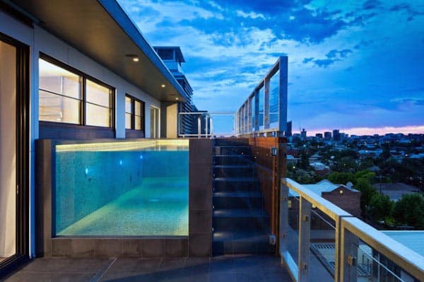 Penthouse Home Swimming Pool With Clear Glass Window Looking Into Blue Water