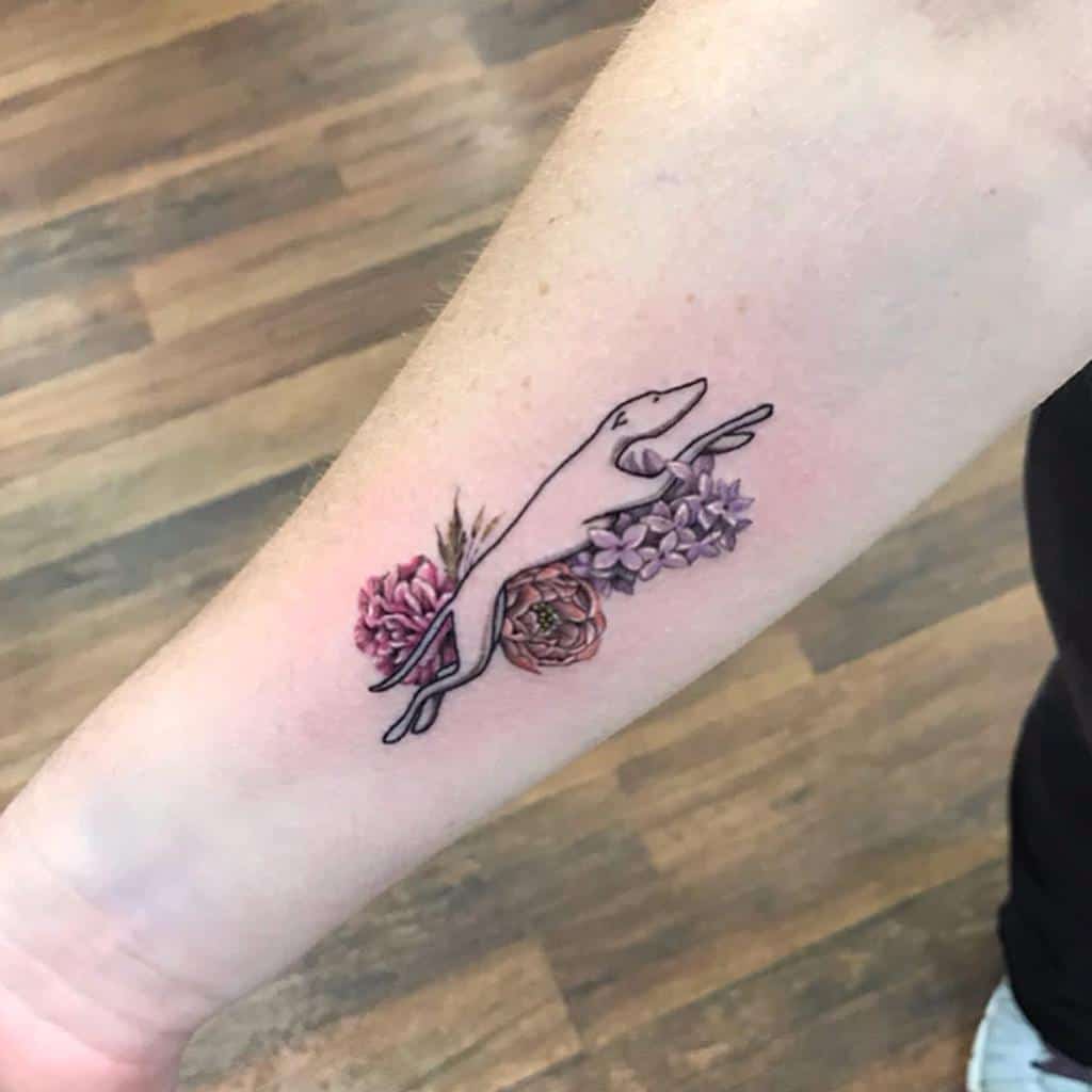 Minimalist tattoo of a sleek, stylized weasel intertwined with lilac and peony flowers, blending fine-line and soft watercolor shading.
