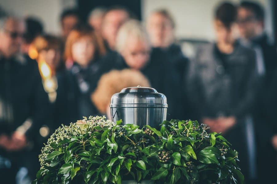 people mourning in the background on a memorial service
