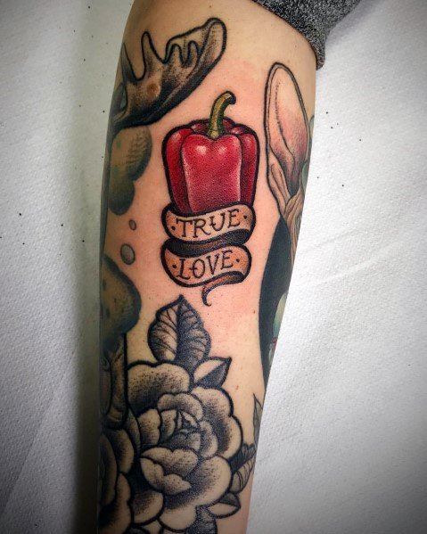 Red bell pepper tattoo with a banner reading "True Love," featuring bold shading and classic tattoo styling for a unique and meaningful design.