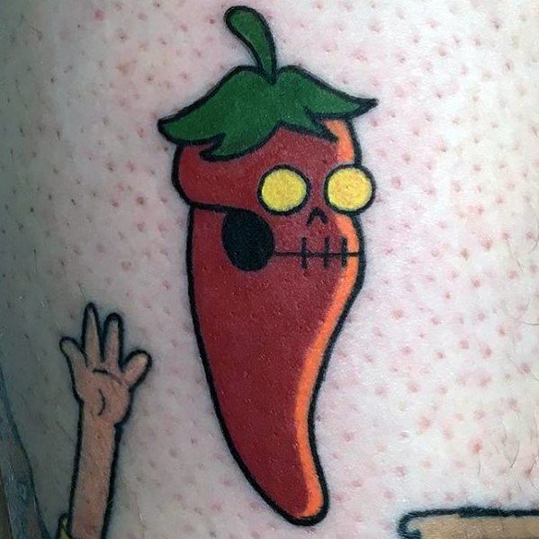 Cartoon-style chili pepper tattoo with a skull-like face, yellow eyes, and bold black outlines for a playful yet edgy design.