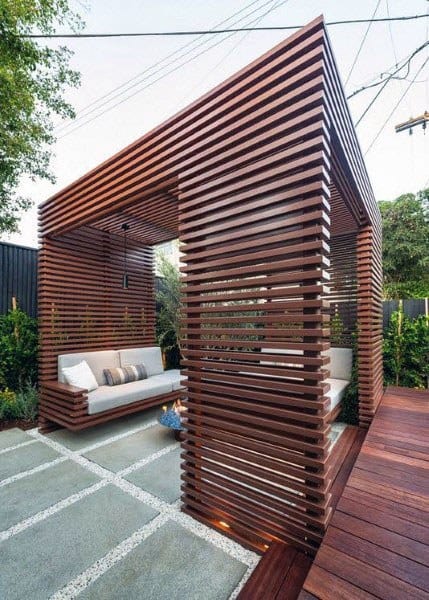 Contemporary pergola with horizontal wood slats, built-in seating, and modern outdoor flooring.