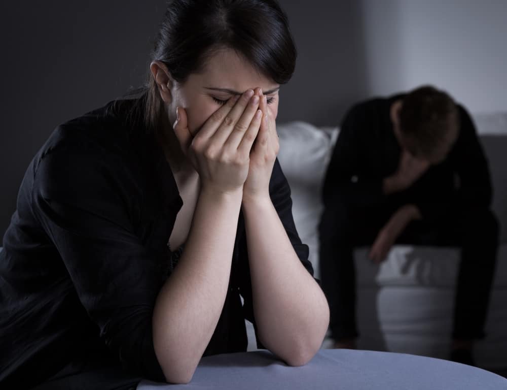 photo of a woman and a man feeling sad