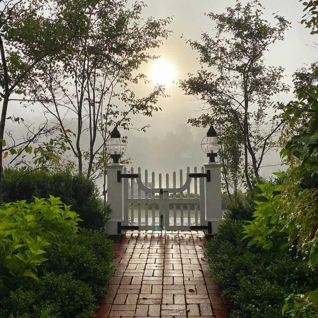 white picket garden gate with lights front yard brick pavers