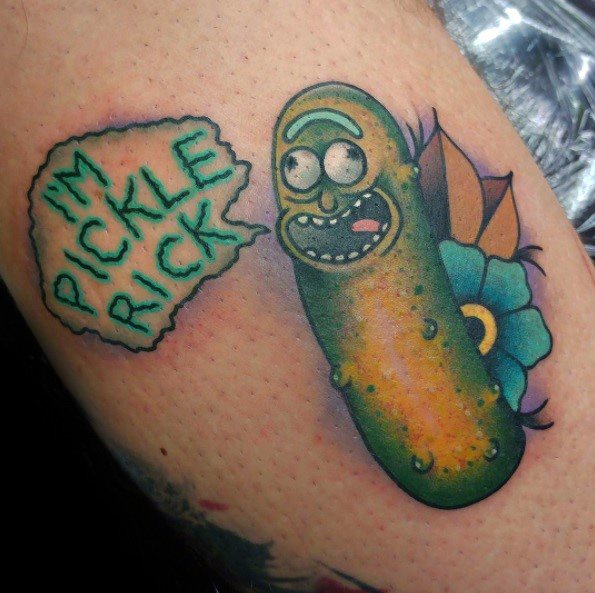 Pickle Rick tattoo with a bold speech bubble saying 'I'm Pickle Rick,' accented by flowers and vibrant shading on the arm.