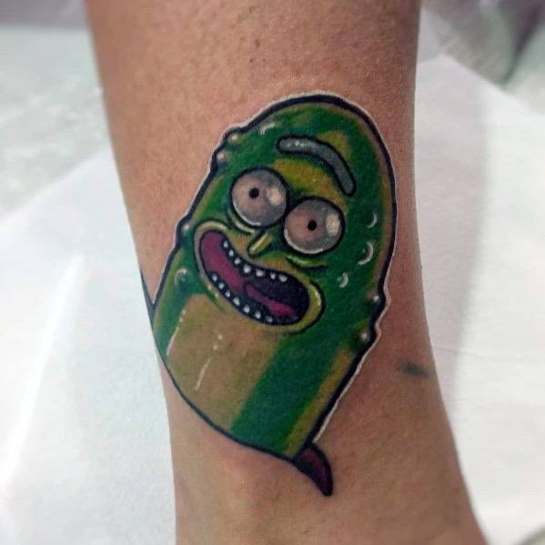 Simple and vibrant Pickle Rick tattoo with bold outlines, bright green shading, and a playful expression, placed on the ankle.