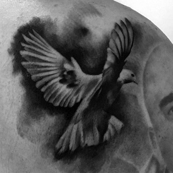 Realistic dove tattoo in flight with soft black and grey shading, symbolizing peace, freedom, and spiritual elevation.