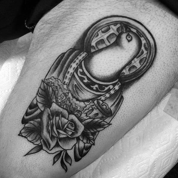 Black and grey pigeon tattoo styled as a saint with a halo resembling a waffle, ornate robes, and roses, mixing humor with religious iconography.