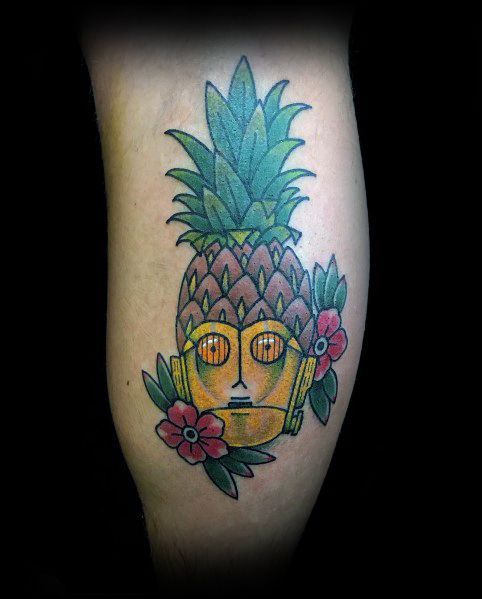 Playful C-3PO tattoo blending the droid’s face with a pineapple, surrounded by tropical flowers, combining sci-fi with a fun, tropical twist.