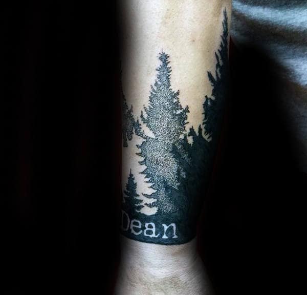 Pine Tree Forest Name Wrist Tattoo For Men With Negative Space Design
